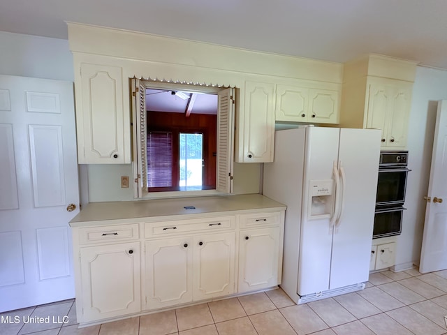 324 Bob White Dr, Canton, MS 39046 - kitchen featuring white fridge with ice dispenser, white cabinetry, light tile patterned floors, and light countertops