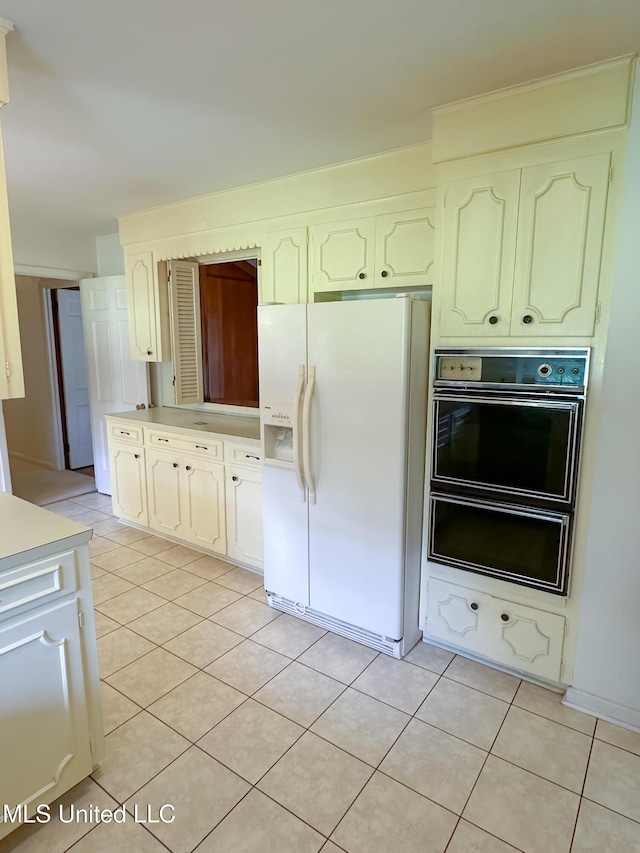 324 Bob White Dr, Canton, MS 39046 - kitchen featuring white refrigerator with ice dispenser, light tile patterned floors, and light countertops