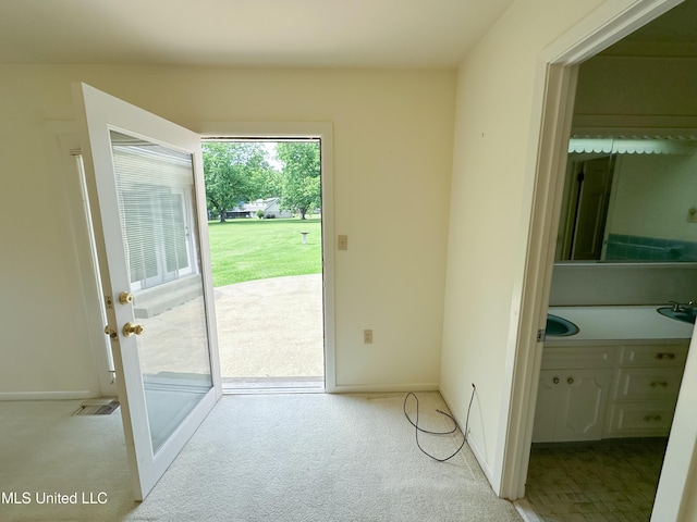 324 Bob White Dr, Canton, MS 39046 - entryway featuring light carpet, baseboards, and a sink