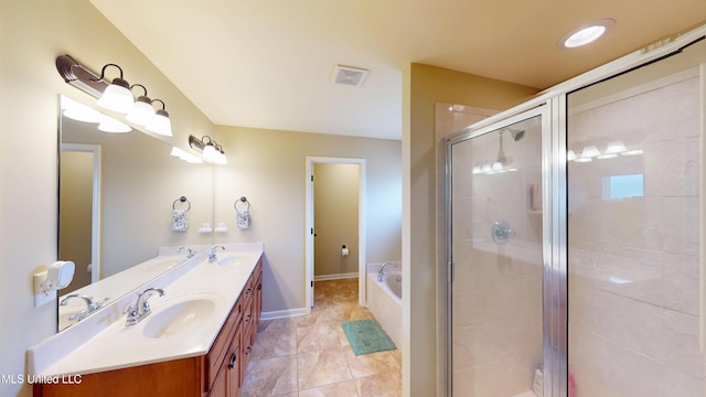 bathroom with vanity and separate shower and tub