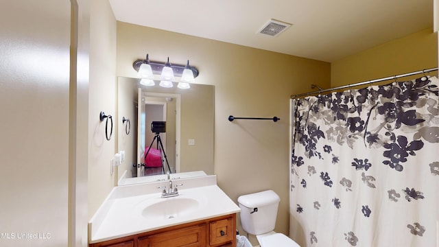 bathroom featuring vanity, toilet, and a shower with shower curtain