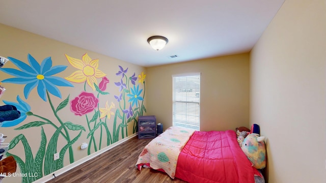 bedroom with dark wood-type flooring