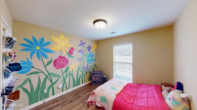 bedroom with dark hardwood / wood-style floors