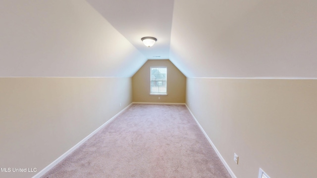 bonus room featuring vaulted ceiling and light carpet