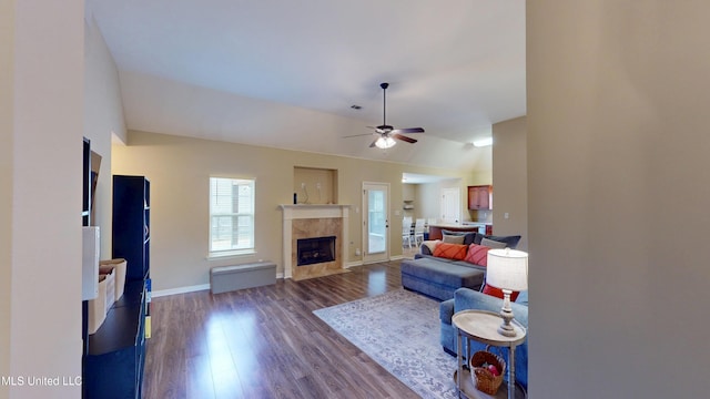 living room featuring dark wood-type flooring, ceiling fan, lofted ceiling, and a high end fireplace