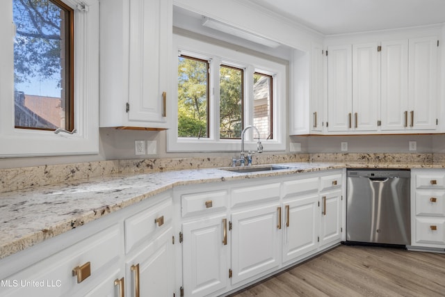 kitchen featuring light stone countertops, white cabinetry, dishwasher, sink, and light wood-type flooring