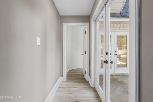 hallway with a wealth of natural light and light wood-type flooring