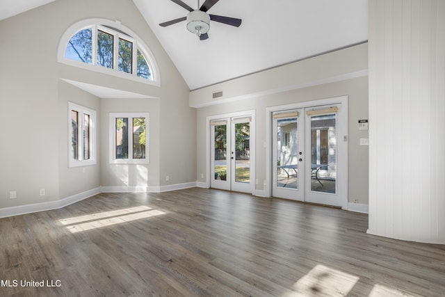 unfurnished living room featuring french doors, dark hardwood / wood-style floors, high vaulted ceiling, and ceiling fan