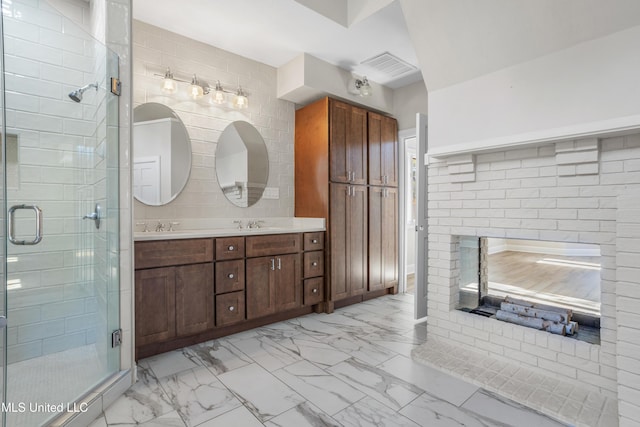 bathroom featuring vanity and a shower with shower door