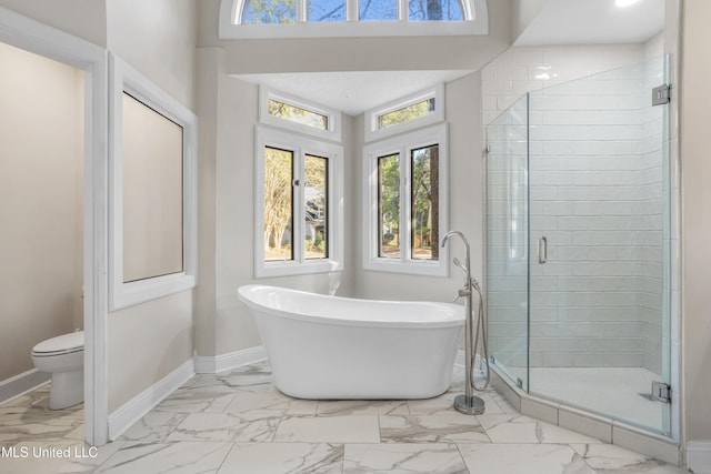 bathroom with toilet, shower with separate bathtub, and french doors