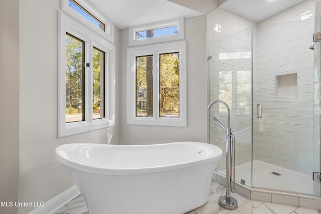 bathroom featuring shower with separate bathtub and a wealth of natural light