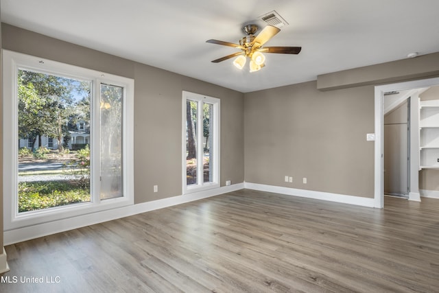 empty room featuring ceiling fan and hardwood / wood-style floors