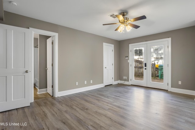 spare room featuring ceiling fan, french doors, and light hardwood / wood-style flooring