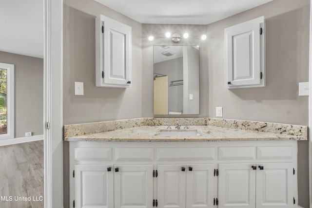 bathroom featuring vanity and hardwood / wood-style flooring