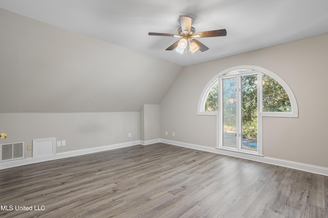 additional living space featuring ceiling fan, lofted ceiling, and hardwood / wood-style flooring