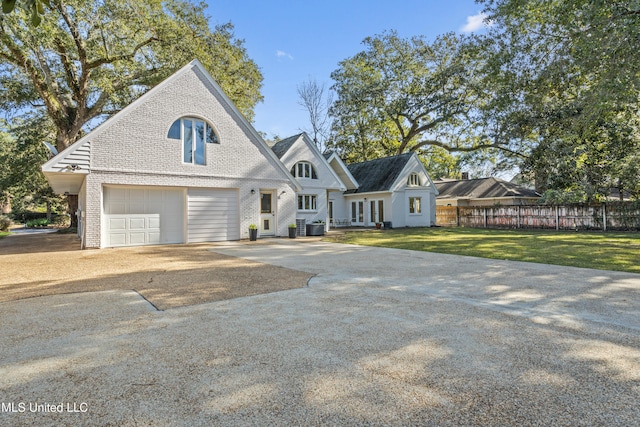 view of front of property featuring a garage, a front lawn, and cooling unit