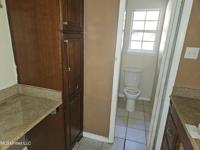 bathroom featuring toilet, vanity, and tile patterned flooring