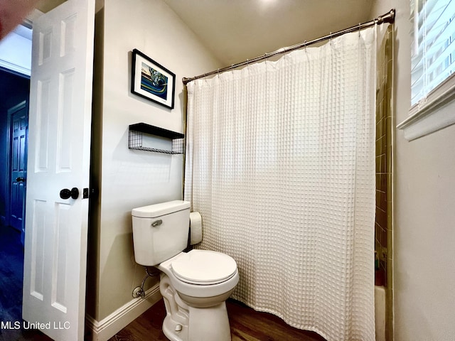 bathroom featuring shower / bath combination with curtain, wood-type flooring, and toilet