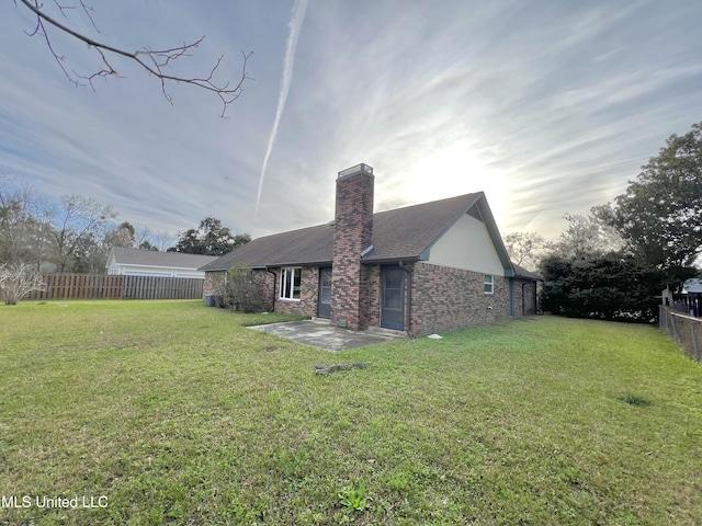 back of house featuring a yard and a patio area