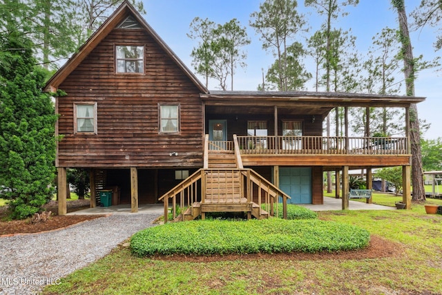 112 Dogwood Ln, Pass Christian, MS 39571 - view of front of property with a garage, gravel driveway, and stairs