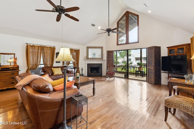 112 Dogwood Ln, Pass Christian, MS 39571 - living area with ceiling fan, high vaulted ceiling, a fireplace, and light wood-type flooring