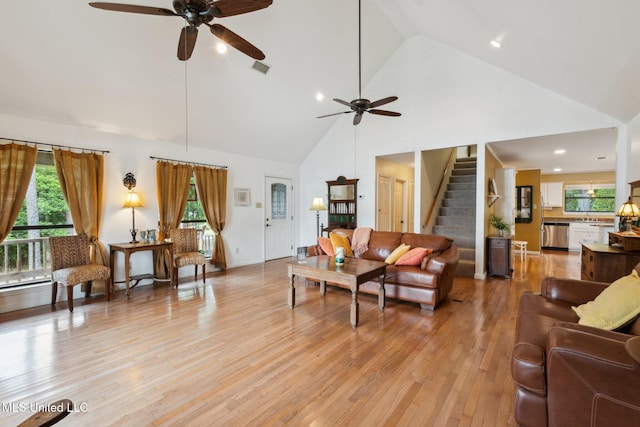 112 Dogwood Ln, Pass Christian, MS 39571 - living room featuring ceiling fan, high vaulted ceiling, stairs, light wood-style floors, and plenty of natural light
