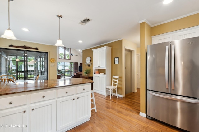 112 Dogwood Ln, Pass Christian, MS 39571 - kitchen featuring freestanding refrigerator, crown molding, light wood-type flooring, white cabinets, and decorative light fixtures
