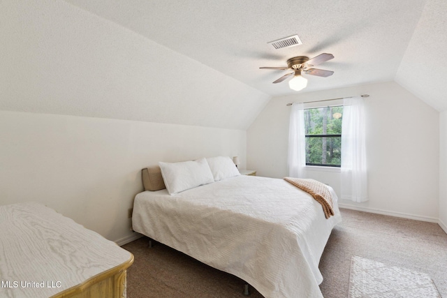 112 Dogwood Ln, Pass Christian, MS 39571 - bedroom with vaulted ceiling, ceiling fan, dark carpet, a textured ceiling, and baseboards