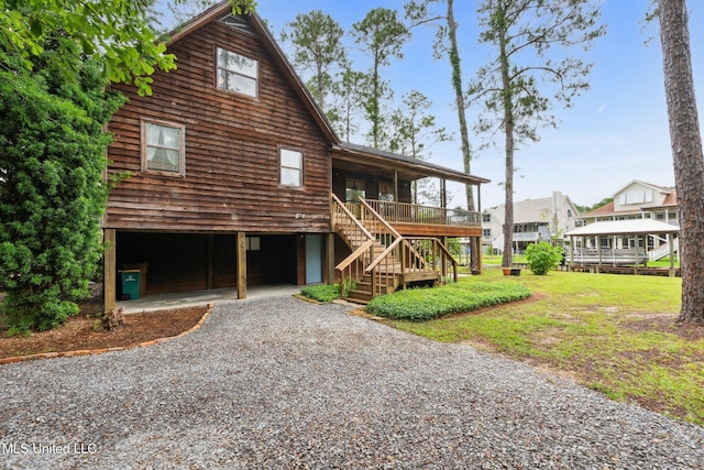 112 Dogwood Ln, Pass Christian, MS 39571 - view of front facade with driveway, stairway, a porch, and a front yard