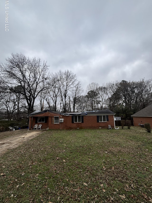 exterior space featuring concrete driveway, a carport, a front yard, and brick siding