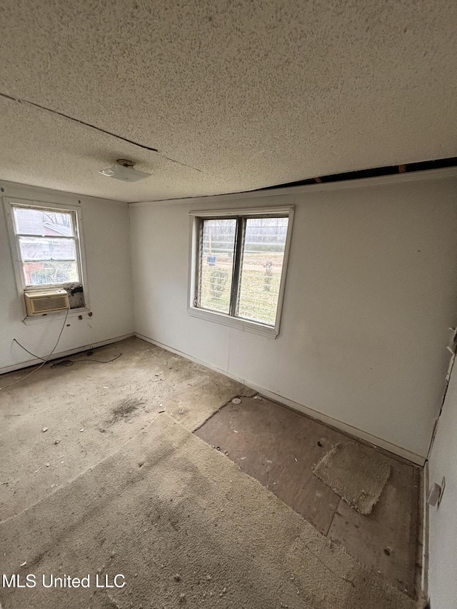 spare room featuring a textured ceiling and cooling unit