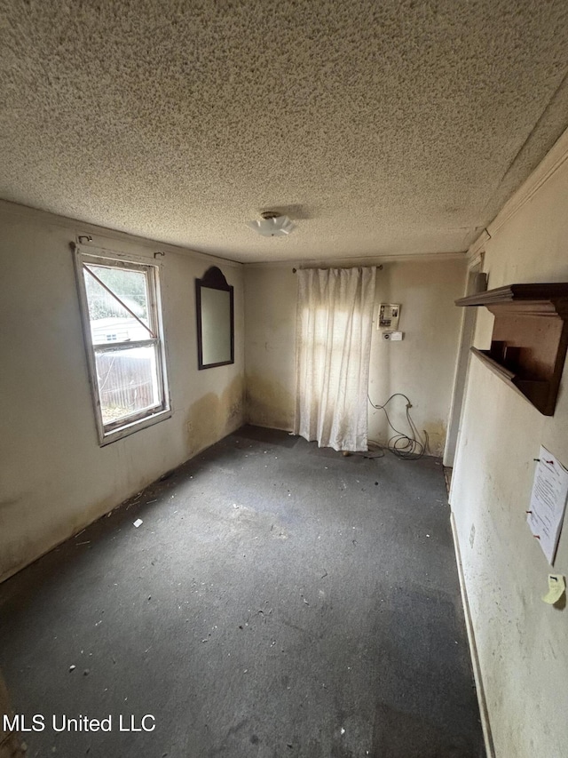 spare room with a textured ceiling