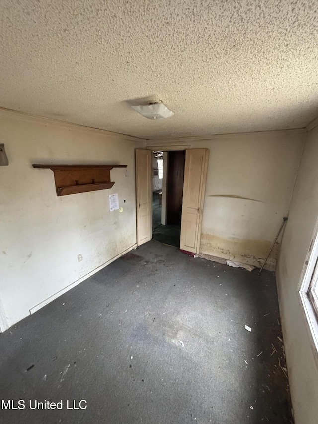 unfurnished room with a textured ceiling