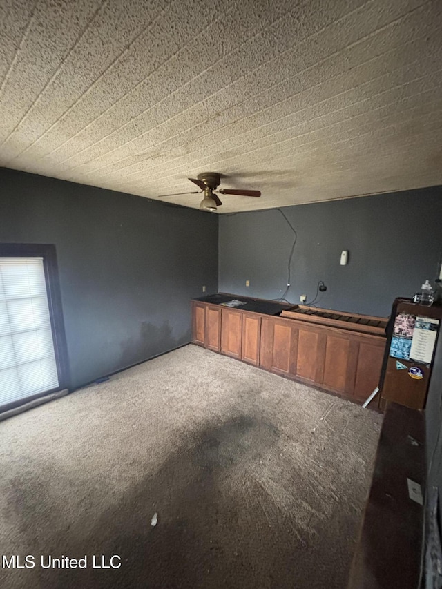 interior space featuring carpet floors and a ceiling fan