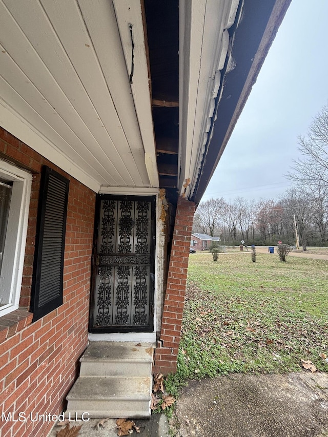 view of exterior entry with brick siding