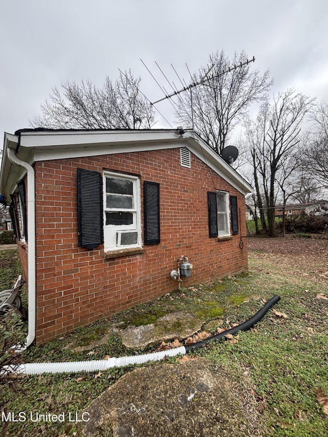 view of side of property featuring brick siding