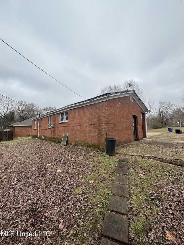 view of side of property featuring brick siding