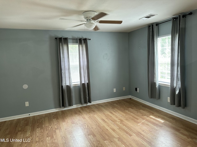 7060 Jefferson St, Bay Saint Louis, MS 39520 - spare room with a ceiling fan, visible vents, light wood-style flooring, and baseboards
