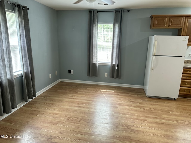 7060 Jefferson St, Bay Saint Louis, MS 39520 - unfurnished dining area with ceiling fan, light wood-type flooring, and baseboards