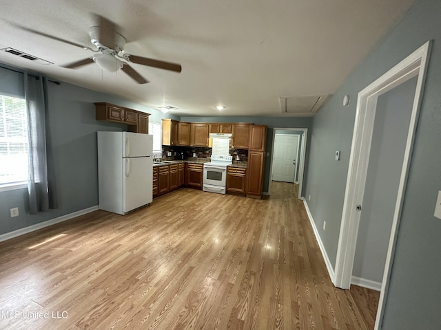 7060 Jefferson St, Bay Saint Louis, MS 39520 - kitchen featuring white appliances, light wood-style floors, ceiling fan, baseboards, and visible vents