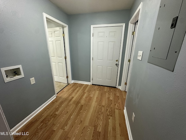 7060 Jefferson St, Bay Saint Louis, MS 39520 - corridor featuring baseboards, light wood-type flooring, and electric panel
