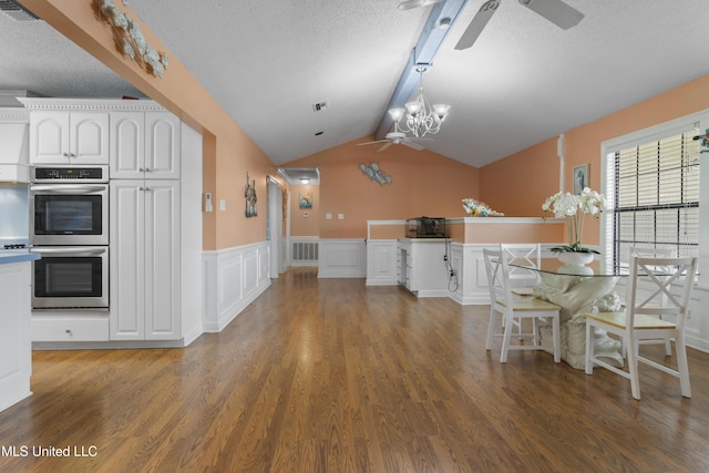 855 Dove Blvd, Bay Saint Louis, MS 39520 - kitchen with a ceiling fan, double oven, wood finished floors, a textured ceiling, and wainscoting