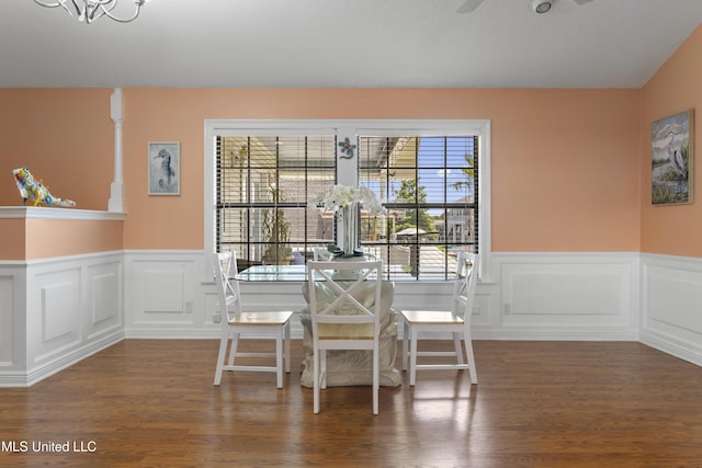 855 Dove Blvd, Bay Saint Louis, MS 39520 - dining space with a chandelier, a wainscoted wall, wood finished floors, a decorative wall, and a ceiling fan