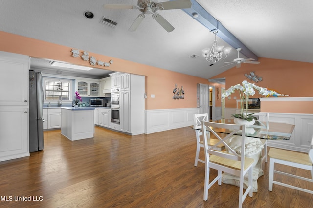 855 Dove Blvd, Bay Saint Louis, MS 39520 - dining room featuring a ceiling fan, a chandelier, wainscoting, a decorative wall, and wood finished floors