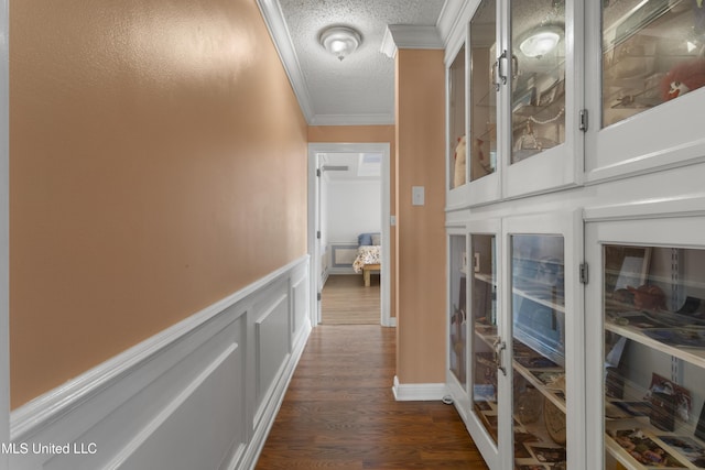 855 Dove Blvd, Bay Saint Louis, MS 39520 - hall with ornamental molding, wainscoting, a decorative wall, dark wood-type flooring, and a textured ceiling