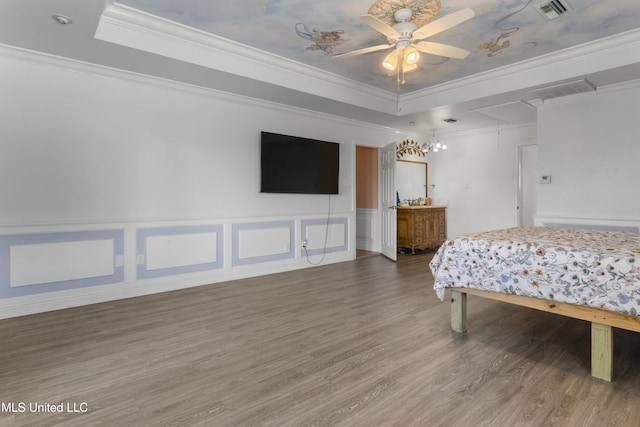 855 Dove Blvd, Bay Saint Louis, MS 39520 - bedroom featuring wood finished floors, a raised ceiling, ornamental molding, attic access, and a wainscoted wall