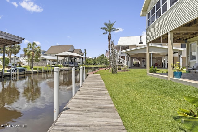 855 Dove Blvd, Bay Saint Louis, MS 39520 - dock area with a water view and a lawn