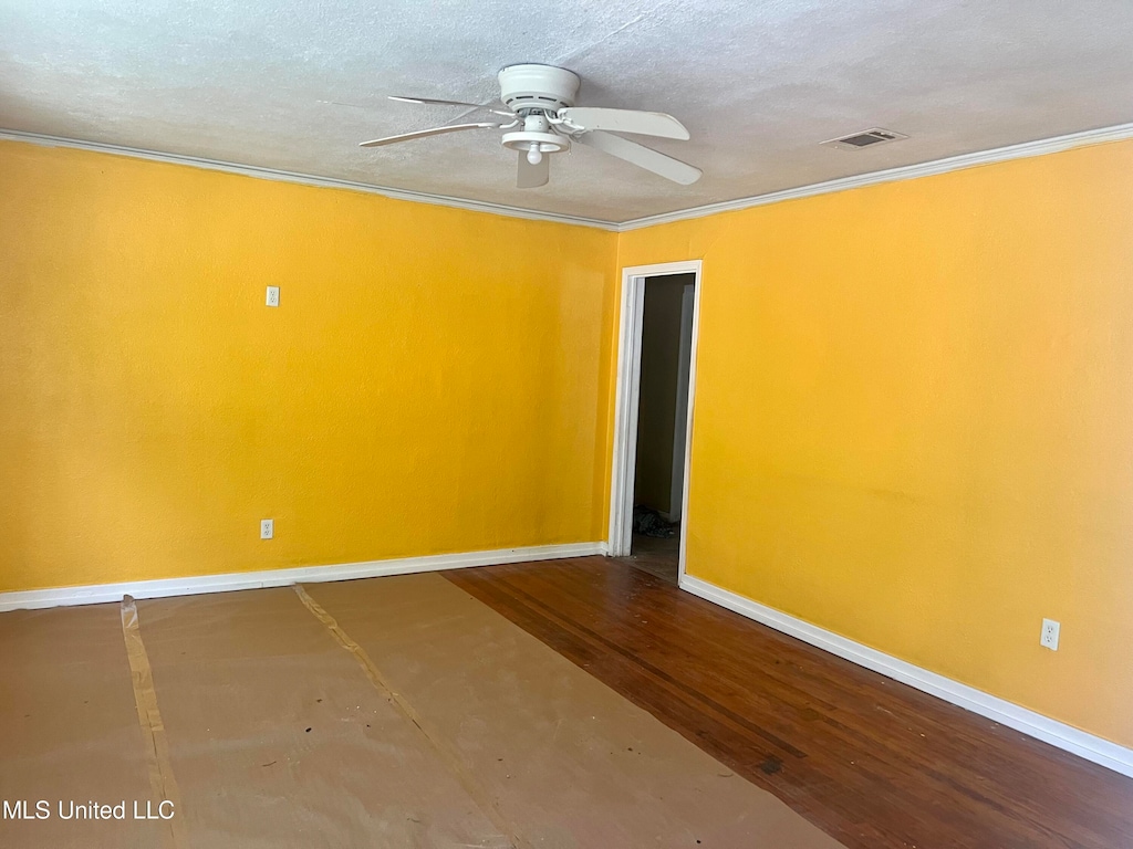 spare room with ceiling fan, hardwood / wood-style flooring, and ornamental molding