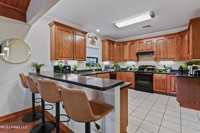 kitchen with kitchen peninsula, sink, black appliances, and ornamental molding