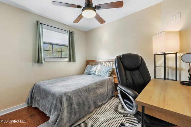 bedroom featuring hardwood / wood-style floors and ceiling fan